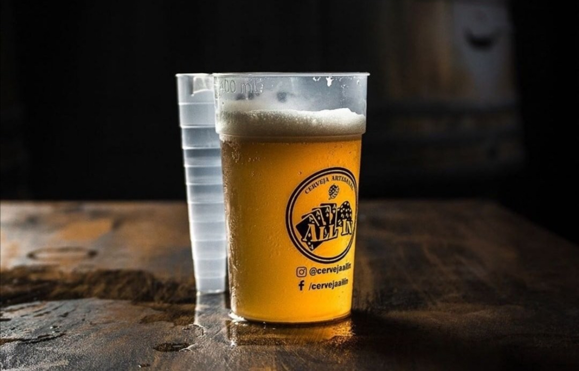A premium branded reusable cup of beer on a bar top